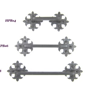 May include: Three black metal door pulls with fleur-de-lis designs. The pulls are labeled HPBs4, HPBs6, and HPBs8.