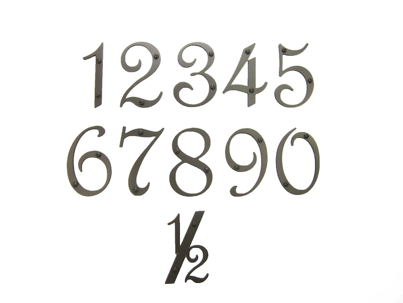 May include: A set of ten metal house numbers in a decorative script font, with the numbers 1 through 10 and a half. The numbers are painted a dark gray color and have small metal rivets.