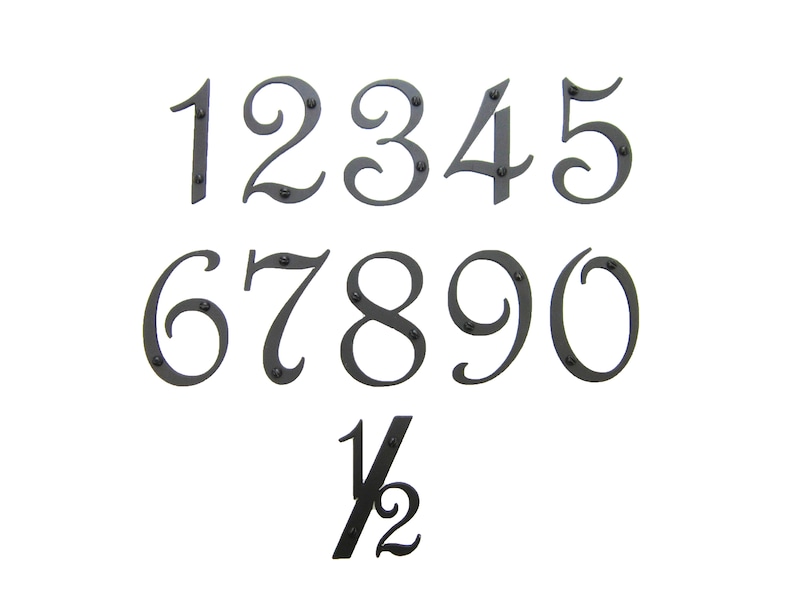 May include: Black metal house numbers 1 through 9 and a half, in a decorative script font. The numbers are attached to a white background.