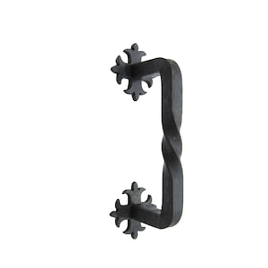 May include: Black metal door pull with a twisted design and decorative fleur-de-lis accents.