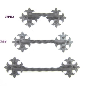 May include: Three black metal door pulls with a twisted design and fleur-de-lis ends. The pulls are labeled HPB4, HPB6, and HPB8.