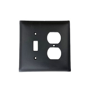 May include: Black metal electrical outlet and light switch cover plate.