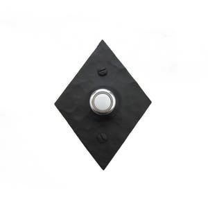 May include: Black diamond-shaped doorbell button with a round, white button in the center.