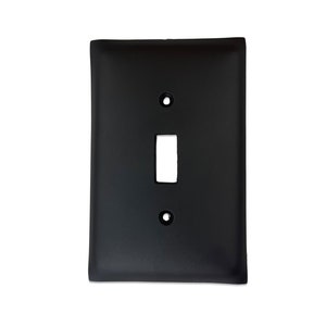 May include: Black single-gang wall plate with a single toggle switch.