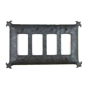 May include: A black metal switch plate with a hammered finish and four rectangular openings. The plate has a decorative design on the corners.