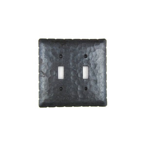 May include: A black hammered metal double light switch cover plate.