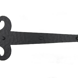 May include: Black wrought iron hinge with a decorative fleur-de-lis design on one end and a scroll design on the other end.