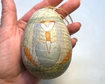 Papier-mâché Garden Themed Easter Egg Ornament with Shovel and Carrots next to Fence, Newsprint, Handmade, Painted, 1980