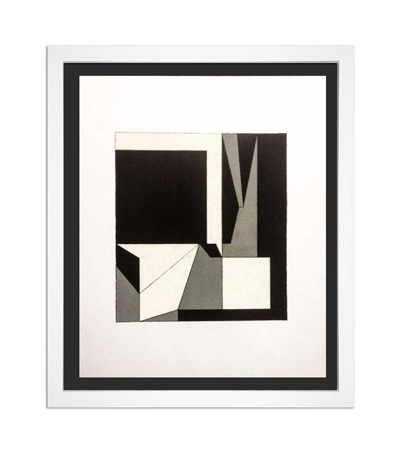 May include: Abstract geometric art print in a white frame with a black border. The artwork features a composition of black, white, and gray shapes, including squares, triangles, and rectangles. The overall design is minimalist and modern.