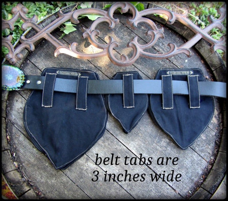 May include: Black canvas belt tabs with white stitching, each measuring 3 inches wide. The tabs are attached to a black leather belt.