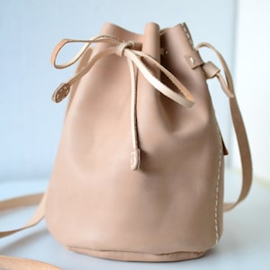 Leather draw string bag, hand stitched round sling bag, Body cross bag. image 1