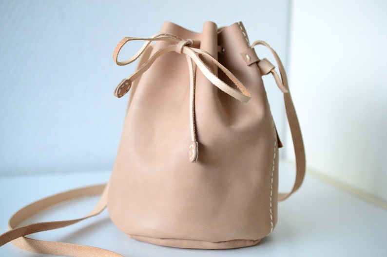 Leather draw string bag, hand stitched round sling bag, Body cross bag. image 1