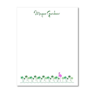 May include: White notepad with green palm trees and a pink flamingo at the bottom. The text "Megan Gardner" is printed in green at the top.