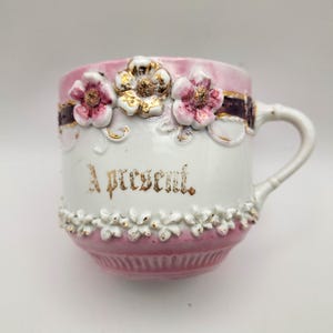 Germany 3&quot; Mustache Mug, &quot;A Present,&quot; Pink Luster, Cherry Blossoms, Gold Trim (c. 1910s)