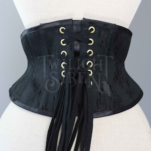 Black cotton flat lacing for corsets, stays gowns or shoes with the ends finished with metal aglets.