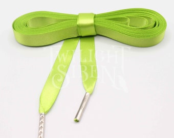 May include: A pair of lime green satin shoelaces with silver metal aglets. The laces are tied in a bow.