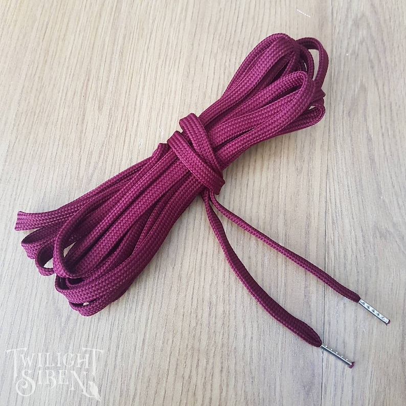 WIne red polyester lacing for corsets or shoes with the ends finished with metal aglets