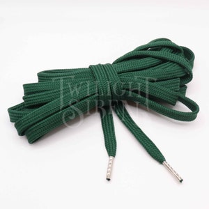 May include: A pair of dark green shoelaces with silver aglets. The shoelaces are made of a thick, woven material.