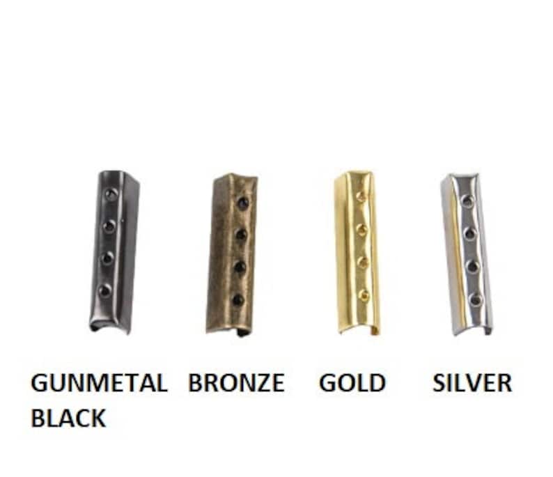 May include: Four metal cord end crimps in gunmetal black, bronze, gold, and silver. Each crimp has four holes for attaching to cords or ribbons. The text below the crimps reads "GUNMETAL BLACK", "BRONZE", "GOLD", and "SILVER".