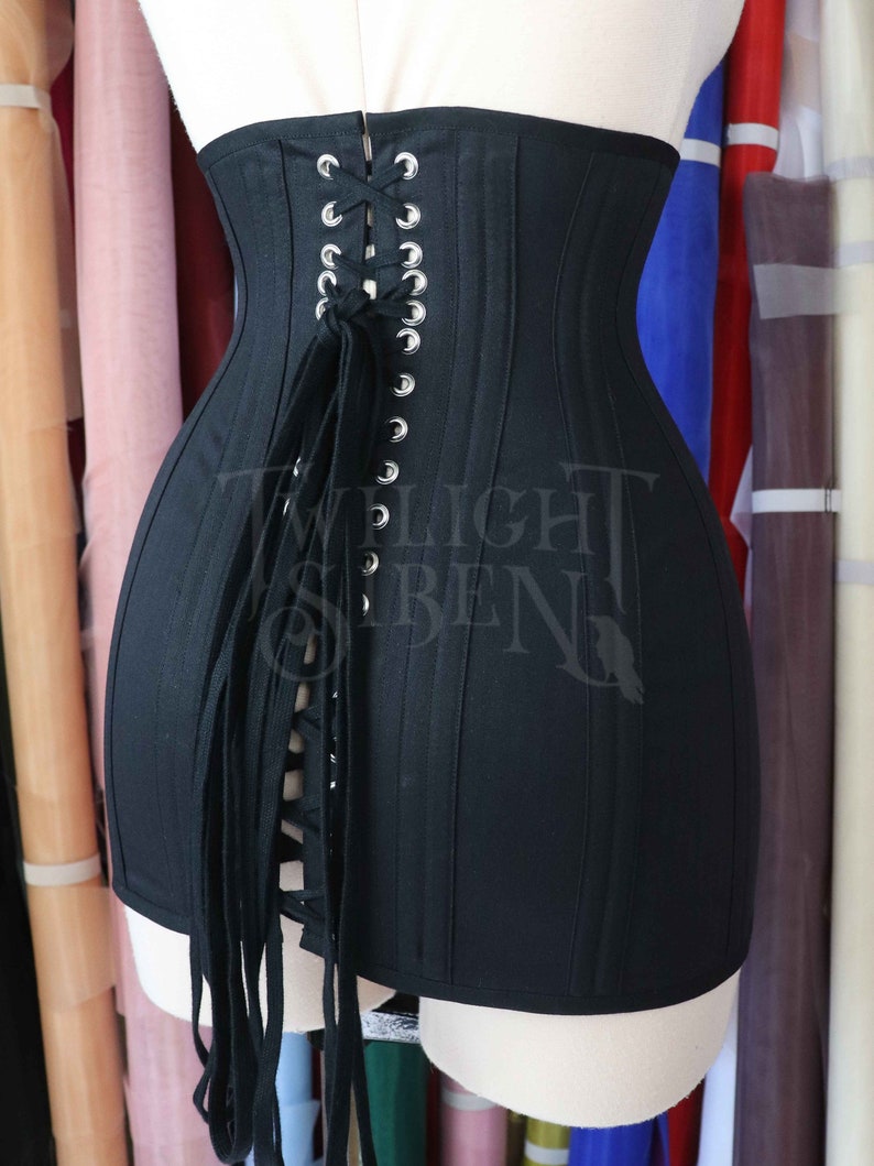 Black cotton flat lacing for corsets, stays gowns or shoes with the ends finished with metal aglets.