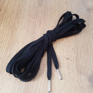 Black cotton flat lacing for corsets, stays gowns or shoes with the ends finished with metal aglets.