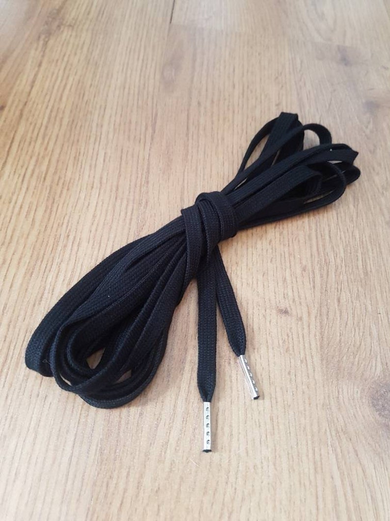 Black cotton flat lacing for corsets, stays gowns or shoes with the ends finished with metal aglets.