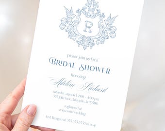 May include: A white invitation with blue text and a decorative crest. The invitation reads "Bridal Shower" and includes details for the event, including the honoree's name, date, time, and location.