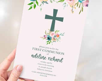 May include: A rectangular invitation card featuring a dark green cross centered above a floral arrangement of pink, peach, and teal watercolor flowers. The text reads: please join us for the FIRST COMMUNION of adeline richard sunday, april 6 10:00 in the morning st. joseph church lafayette, louisiana CAKE AND REFRESHMENTS TO FOLLOW.