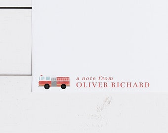 May include: White stationery with a red and white fire truck illustration. The text "a note from OLIVER RICHARD" is printed in red. The stationery is on a white wooden surface.