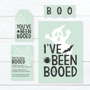 May include: A set of printable Halloween signs featuring a ghost, spider, bat, and spiderweb graphics. The signs say "You've Been Booed" and "I've Been Booed".