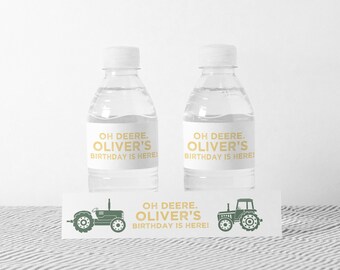 May include: Two clear plastic water bottles with white labels that say "OH DEERE. OLIVER'S BIRTHDAY IS HERE!"  A green tractor graphic is on a white label that says "OH DEERE. OLIVER'S BIRTHDAY IS HERE!"