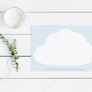 May include: A light blue card with a white cloud shape in the center. The text "a little note from OLIVER RICHARD" is printed at the bottom of the card.
