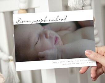 May include: A white birth announcement card with a photo of a sleeping newborn baby. The card reads "oliver joseph richard" and "april 6, 2019 at 12:45 pm 7 lbs 2 oz 21 inches welcomed with love. Reagan & Steve."