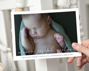 May include: A newborn baby boy named Oliver Joseph Richard, born on April 6, 2019 at 12:45 pm, weighing 7 pounds 2 ounces and measuring 21 inches. The baby is wrapped in a light blue blanket and is sleeping peacefully.