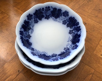 May include: Three white ceramic bowls with a blue and white grapevine pattern. The bowls are stacked on top of each other.