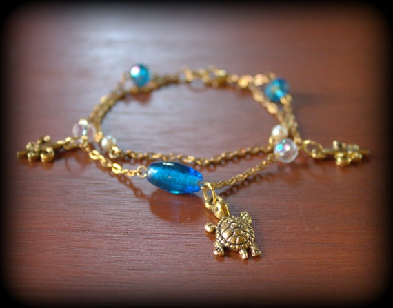 Delicate Golden Turtle Fleur De Lys Double Charm Bracelet Decorated With Crystal Bleu De France Beads And Delicate Pearls Ready