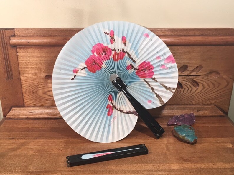 Vintage oriental paper folding hand fan with cherry blossoms