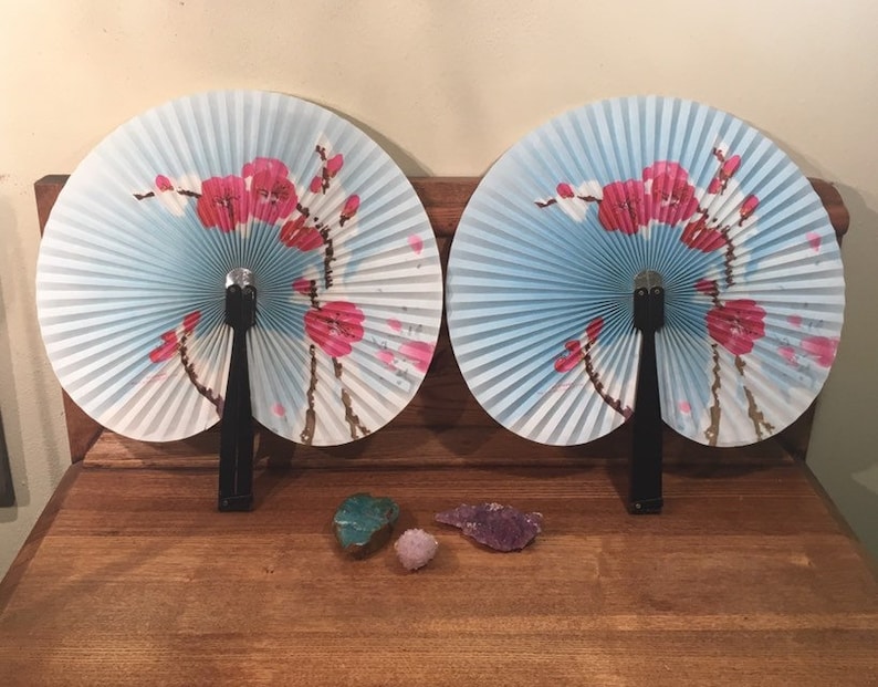 Vintage oriental paper folding hand fan with cherry blossoms