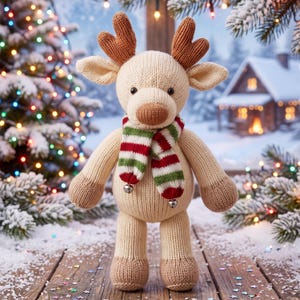 May include: A knitted cream-colored reindeer plush toy featuring brown antlers and a brown nose. The reindeer wears a striped scarf in red, white, and green with two small silver jingle bells attached to the ends of the scarf fabric.