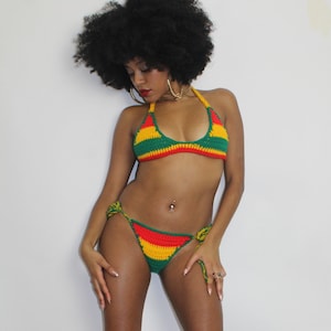 May include: A crochet bikini top and bottom in green, yellow and red stripes. The bikini is a halter style with a tie at the back. The bottom is a high-cut style with ties on the sides.