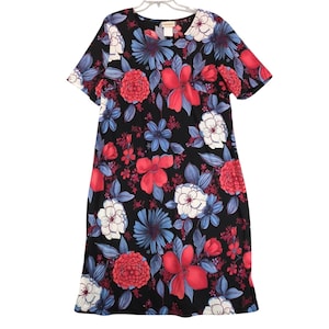 May include: A black knee-length dress featuring a vibrant floral pattern with large red, blue, and white flowers and green leaves. The garment has short sleeves, a round neckline, and a straight silhouette, providing a consistent floral print.