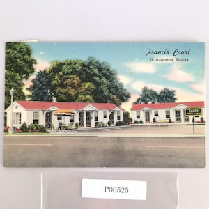 May include: Vintage postcard featuring Francis Court in St. Augustine, Florida. The image shows a row of white buildings with red roofs, trees, and a blue sky. The postcard has the text "Francis Court" and "St. Augustine, Florida".
