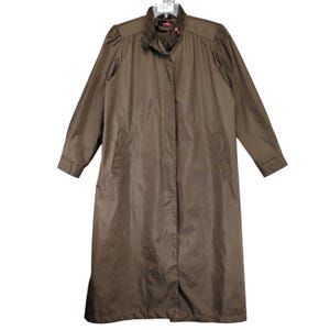May include: A long brown raincoat with a corduroy collar and a button closure. The collar has a red and white floral pattern.
