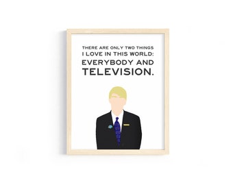 May include: A framed print with a white background and black text that reads "THERE ARE ONLY TWO THINGS I LOVE IN THIS WORLD: EVERYBODY AND TELEVISION."  A cartoon illustration of a man with blonde hair wearing a black suit and blue tie is below the text.