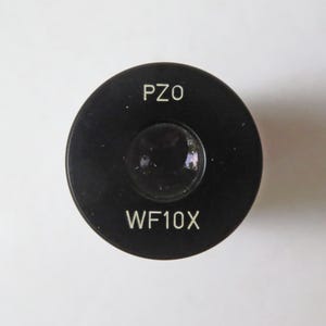 May include: A black microscope eyepiece with the text "PZO WF10X" printed on it.