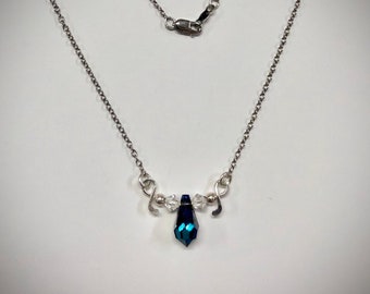 Cut Crystal, Bermuda Blue Teardrop with a Sterling Silver Forged Ribbon Going Through the Crystal