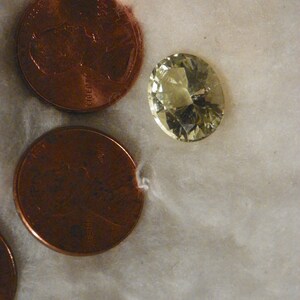 Aquamarine 6.22 Carats 10.80x13.30x7.85 MM. Oval Pale Yellow Green Moderate Natural Inclusions