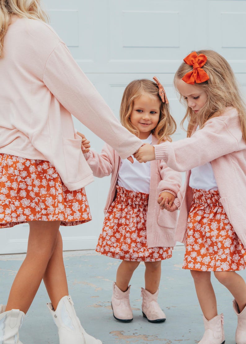 Op de afbeelding: Set van drie keramische mokken met een gespikkelde, matte afwerking. De mokken zijn in cr&egrave;me, lichtgrijs en donkergrijs. Elke mok heeft een eenvoudig, minimalistisch ontwerp.