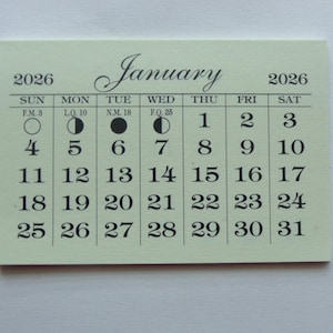 May include: A light green calendar for January 2026 with black text and moon phase icons. The calendar shows the days of the week, the dates, and the moon phases for each day.