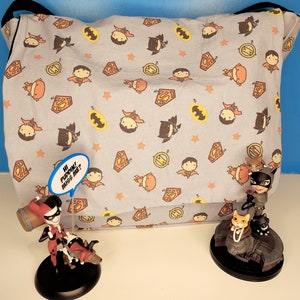 Messenger Bag with Chibi Super Heroes on Blue Background.